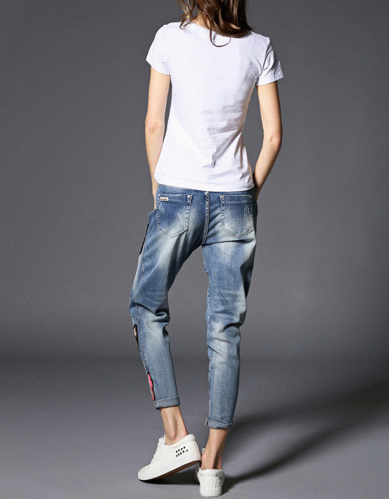 Jeans with sewn-on sequins and butterfly motifs