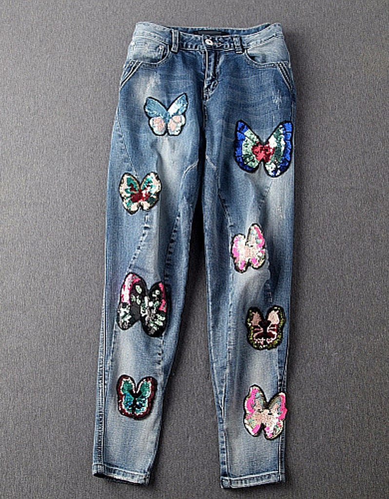 Jeans with sewn-on sequins and butterfly motifs