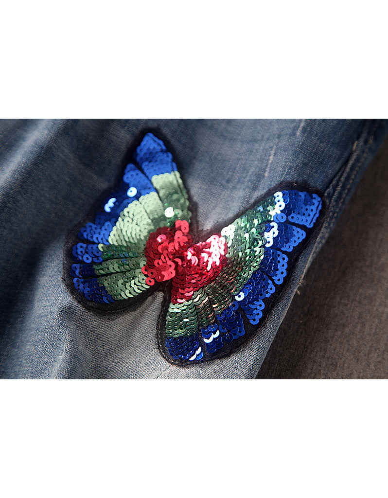 Jeans with sewn-on sequins and butterfly motifs