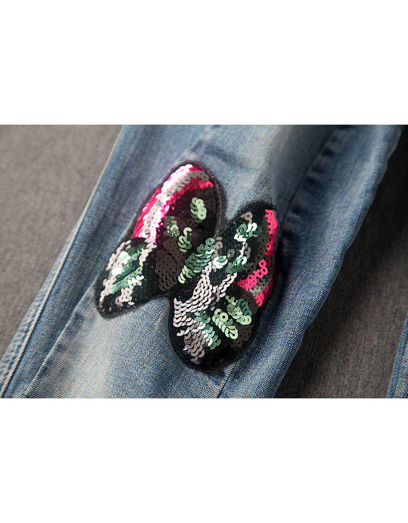 Jeans with sewn-on sequins and butterfly motifs