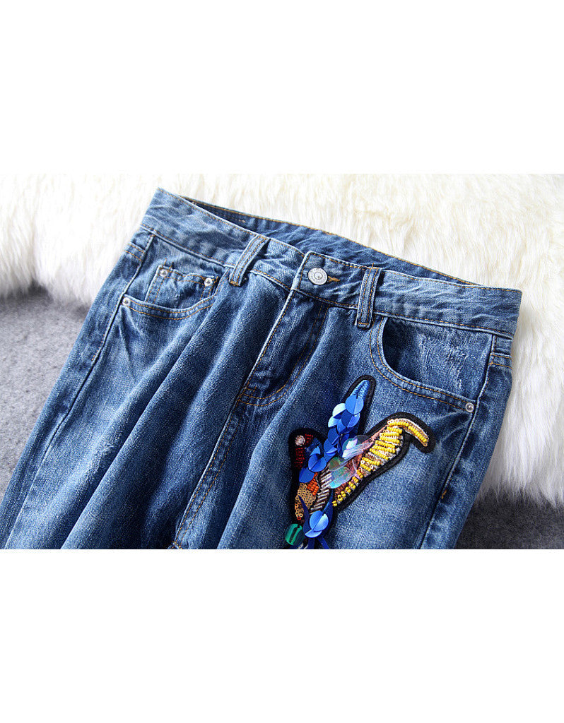 Distressed jeans with birdie design in sequins, beads and embroidery