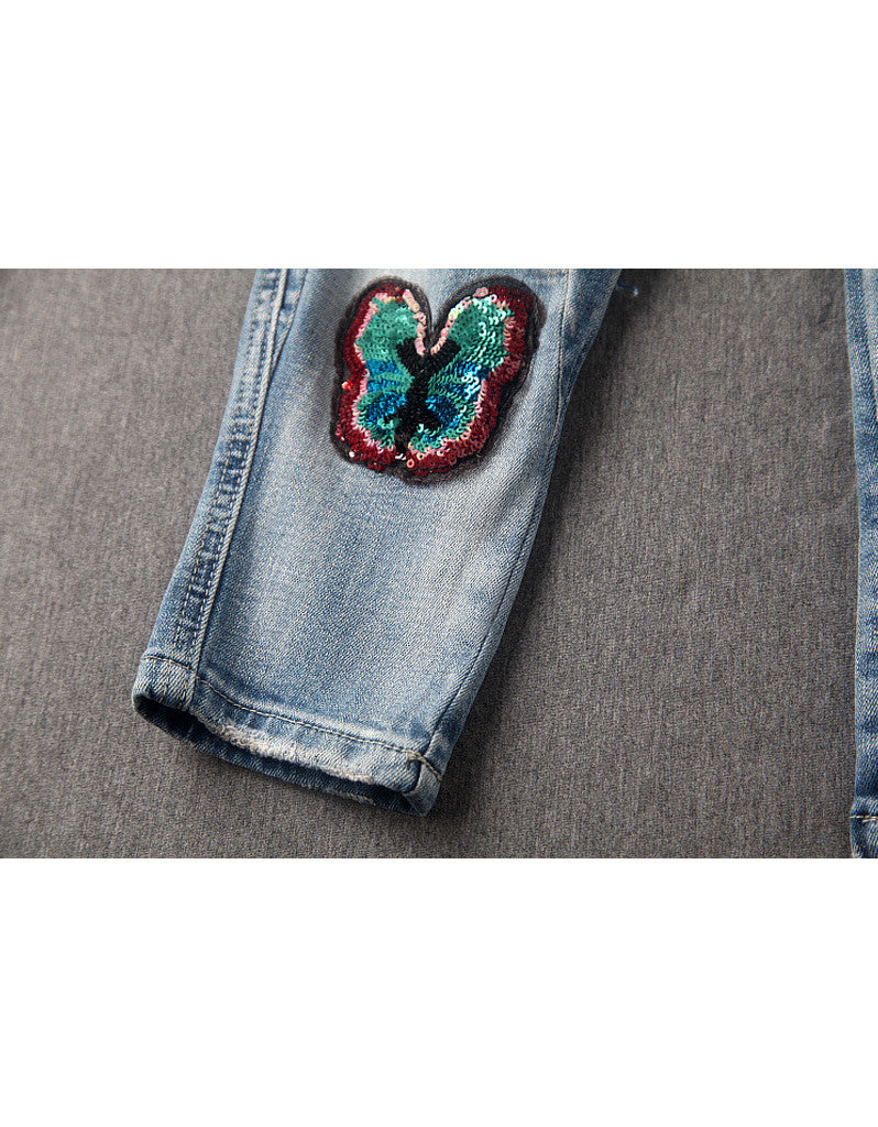Jeans with sewn-on sequins and butterfly motifs