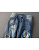 Jeans with sewn-on sequins and butterfly motifs