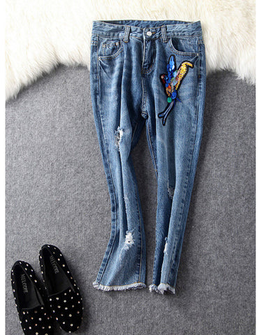 Jeans with sewn-on sequins and butterfly motifs