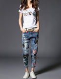 Jeans with sewn-on sequins and butterfly motifs