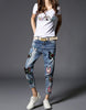 Jeans with sewn-on sequins and butterfly motifs